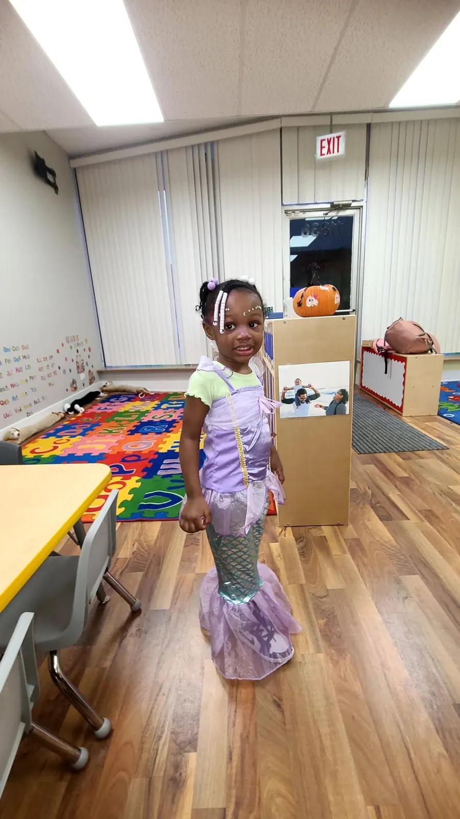 Child in a mermaid costume in the classroom